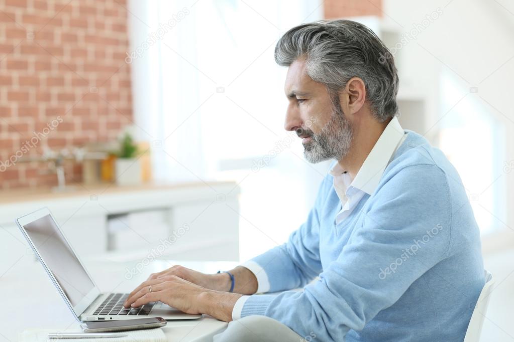 Businessman working from home with laptop