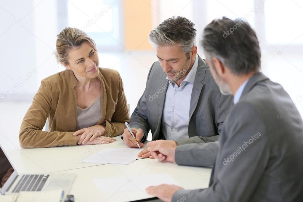 Couple signing financial contract