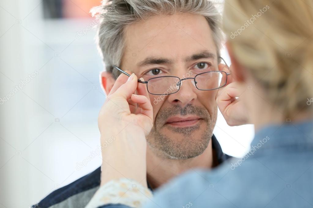 Man trying eyeglasses on
