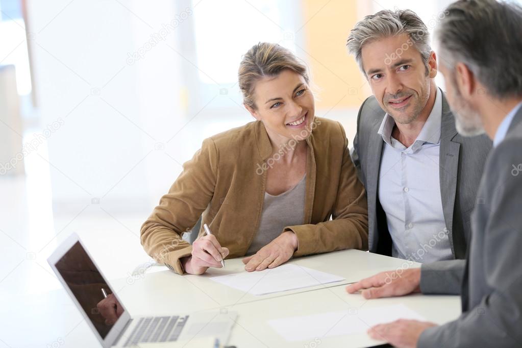 Couple signing financial contract