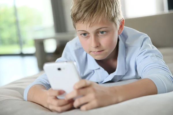 Boy playing with smartphone — Stock Photo, Image