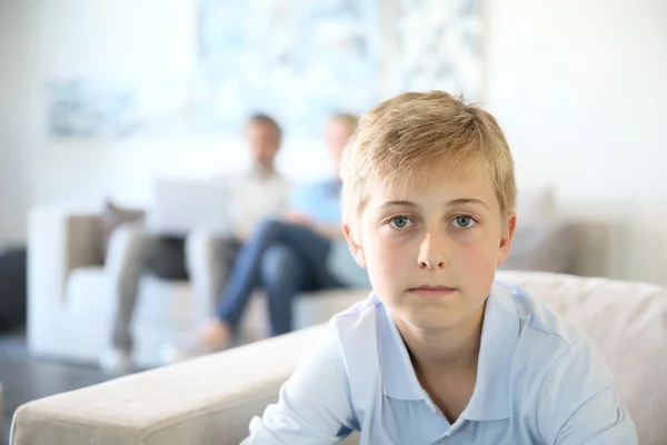 Boy sitting on couch — Stock Photo, Image