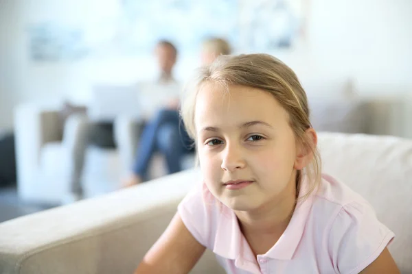 Girl sitting on sofa — Stock Photo, Image