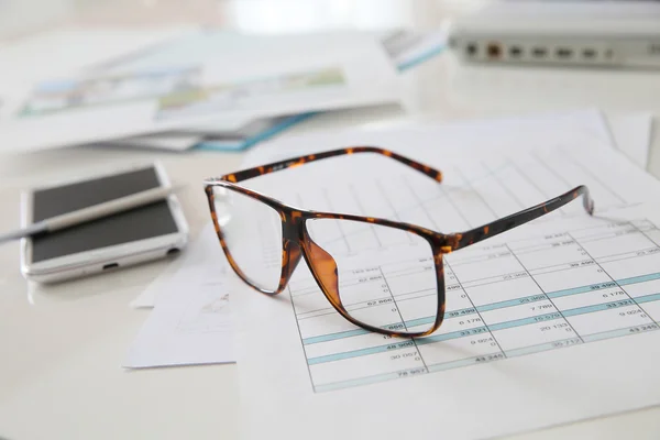Eyeglasses on meeting table — Stock Photo, Image