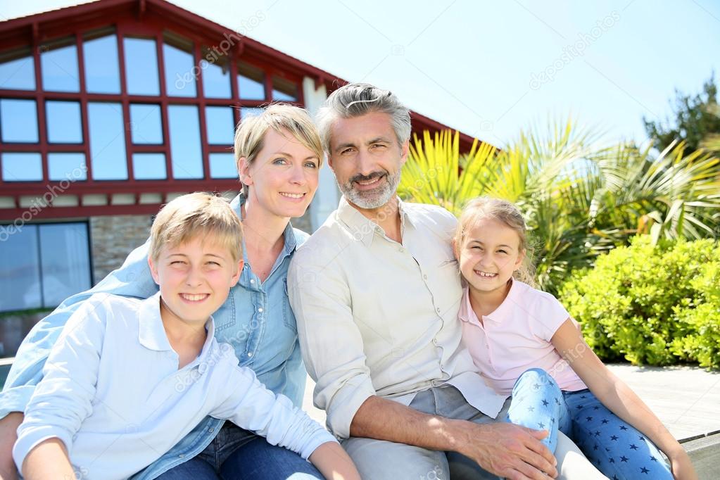 Family in front of contemporary house