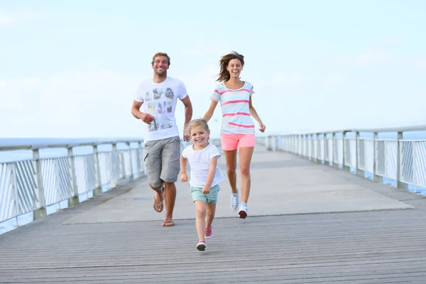 Le menina com os pais correndo — Fotografia de Stock