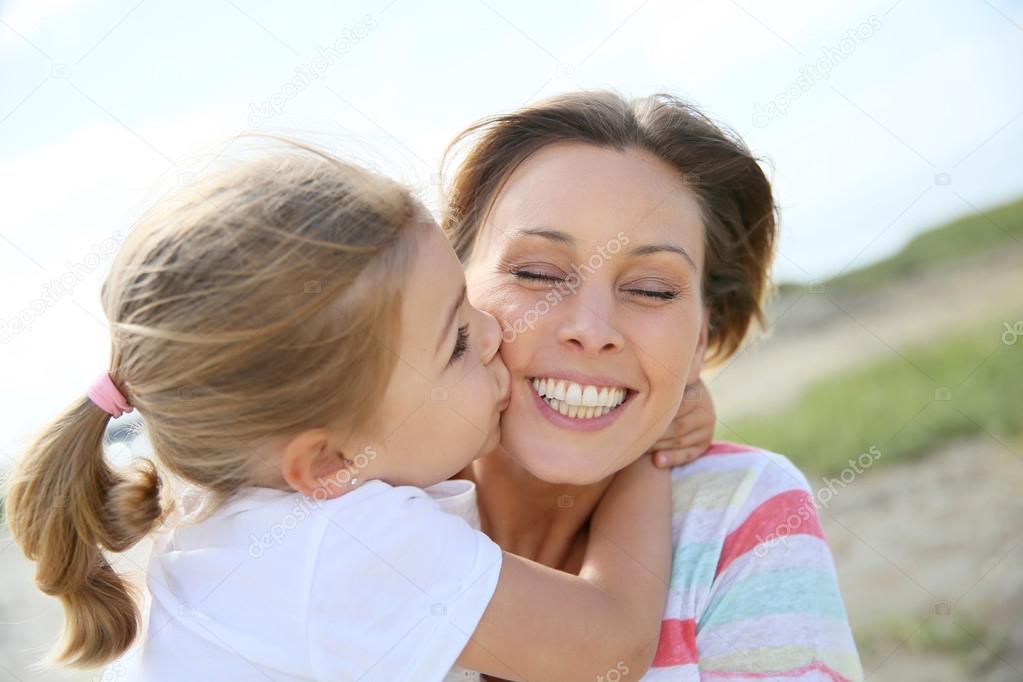 little girl kissing her mom