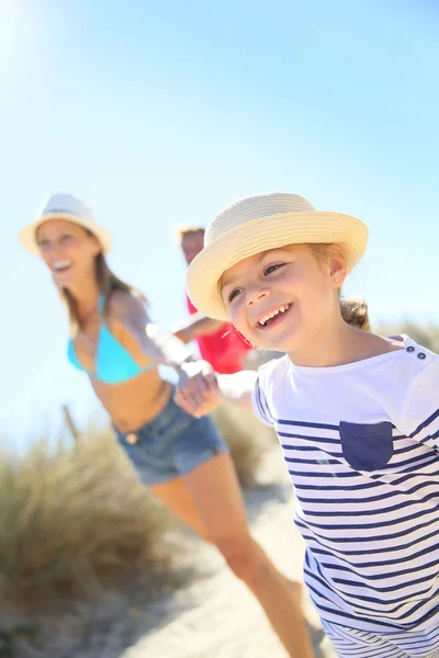 Girl pulling parents' arms — Stock Photo, Image