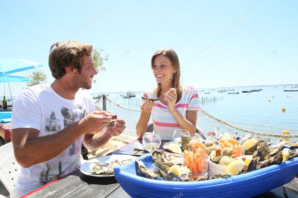 Couple tasting fresh oysters