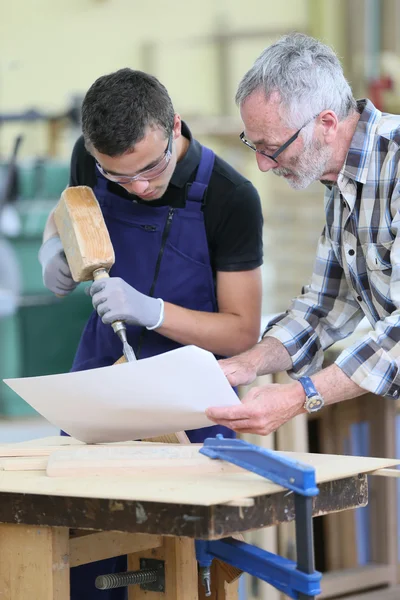 Young apprentice with teacher working — Stock Photo, Image