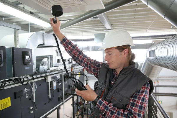 Technician controlling equipment — Stock Photo, Image
