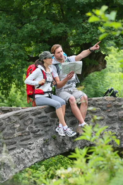 Randonneurs lisant la carte sur un pont en pierre — Photo