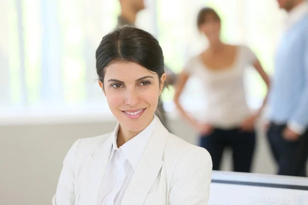 Businesswoman standing in business room — Stock Photo, Image