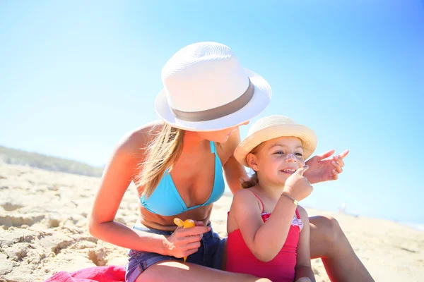 Mujer que aplica protector solar — Foto de Stock