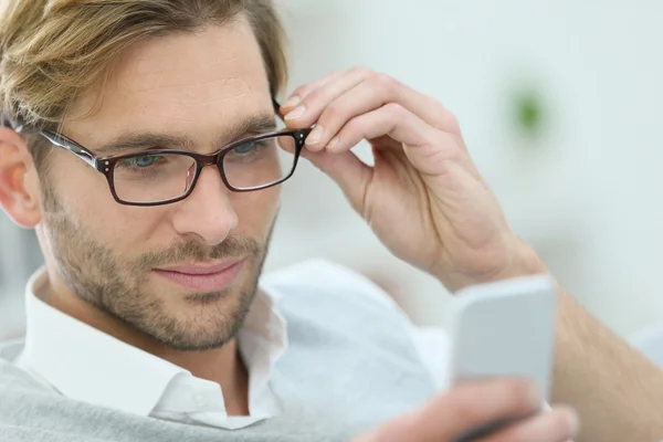 Człowiek z okularów do czytania wiadomości — Zdjęcie stockowe