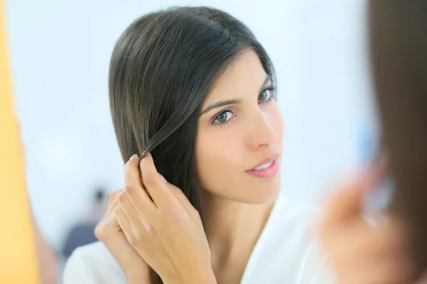 Mujer joven mirando su piel —  Fotos de Stock