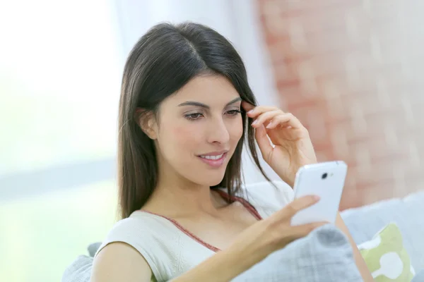 Mädchen benutzt Smartphone zu Hause — Stockfoto