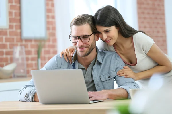 Pareja en casa websurf en el ordenador portátil —  Fotos de Stock