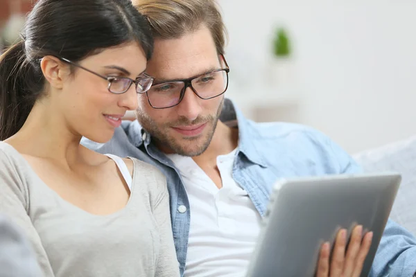 Couple with eyeglasses websurfing Stock Picture