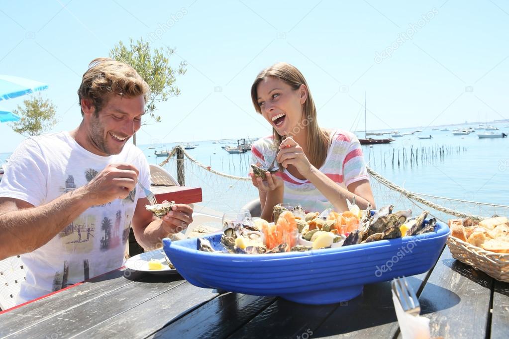 Couple tasting fresh oysters