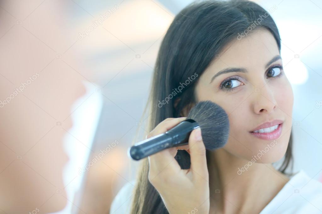 woman using powder brush