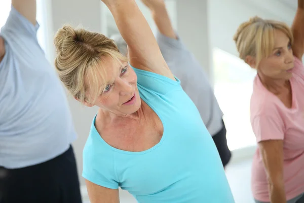 Senior people stretching out — Stock Photo, Image