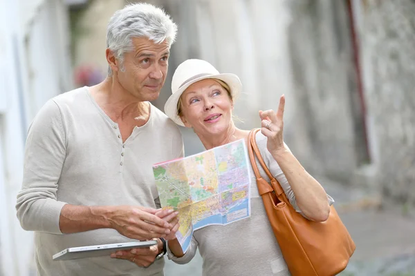 Старшие туристы, идущие по улице — стоковое фото