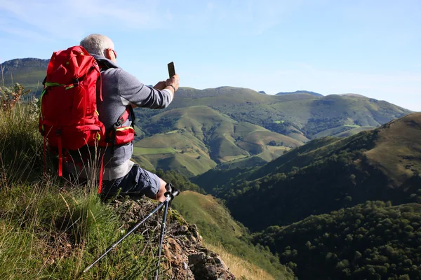 Hiker in Pyrenees mountains taking picture — Stock Photo, Image