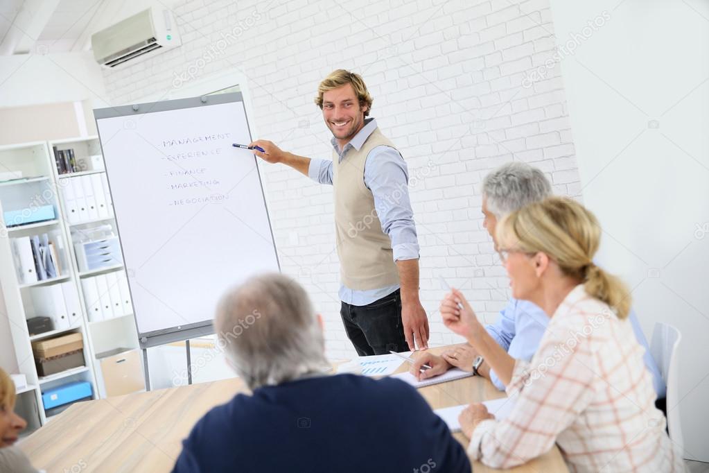 Business instructor leading meeting — Stock Photo © Goodluz 85185908