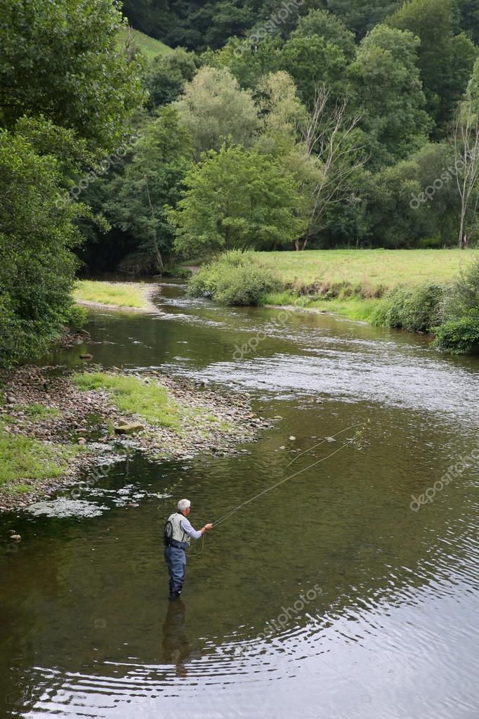 Fly fisherman fishing — Stock Photo © Goodluz #85185928