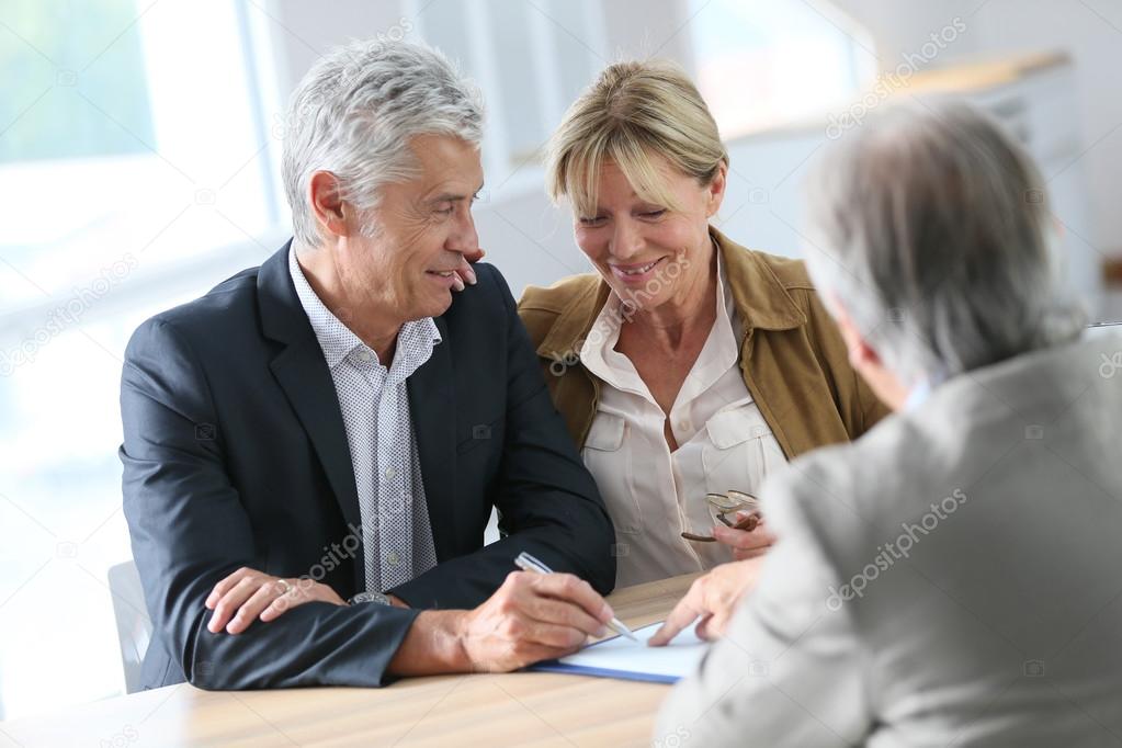 couple meeting real-estate agent for investment