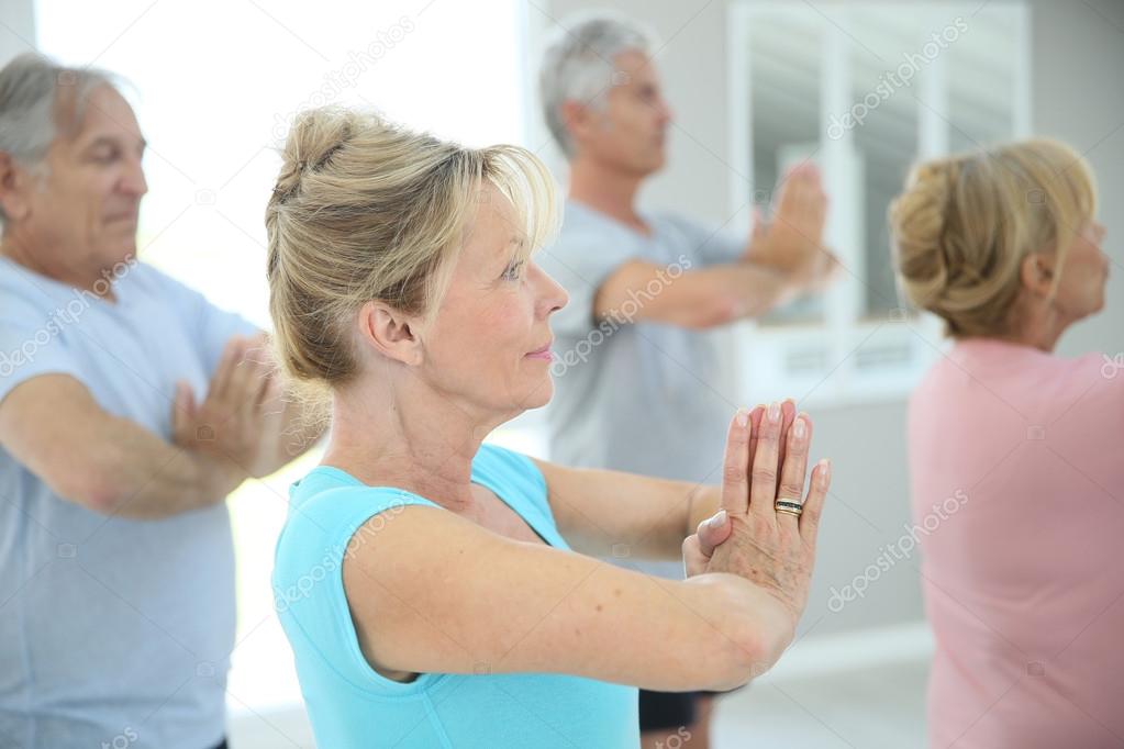 people doing fitness exercises in gym