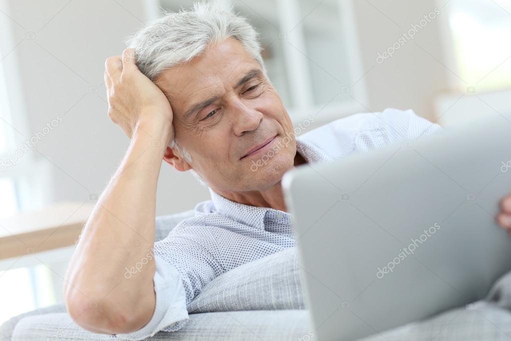 man  using digital tablet