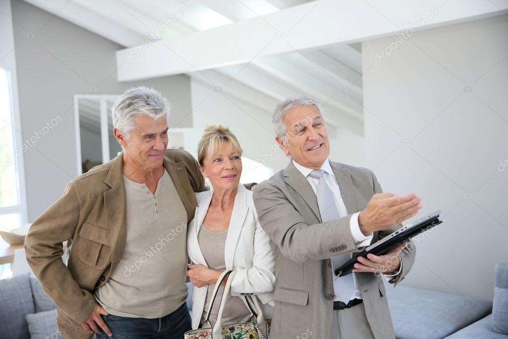 Senior couple with real-estate agent