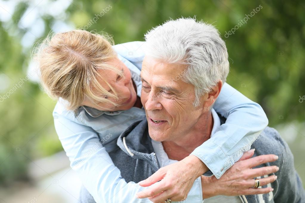 man giving piggyback ride to his wife