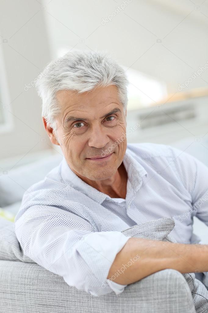 elderly man relaxing in sofa at home