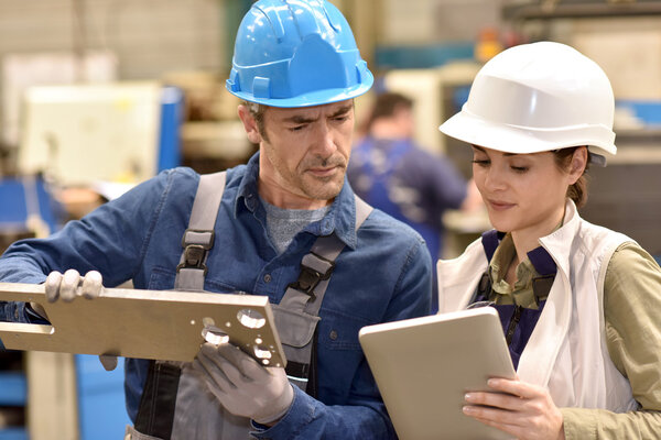 Metallurgy workers using digital tablet
