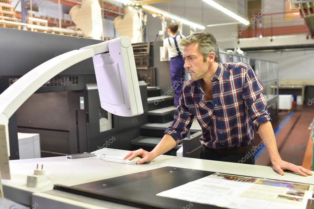 Man working on printing machine