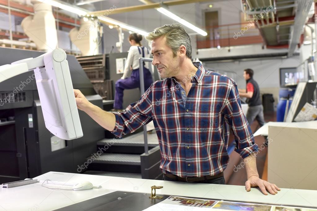 Man working on printing machine