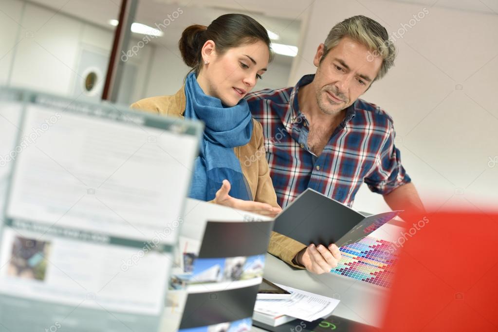 Client in printshop controlling work