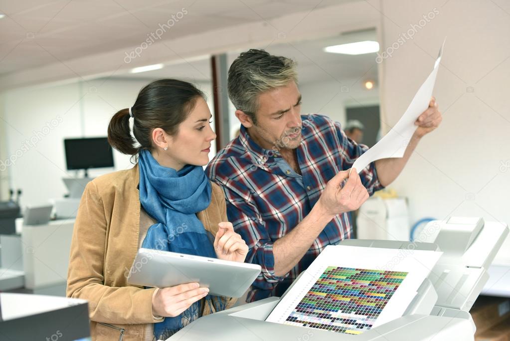 Client in printshop controlling work