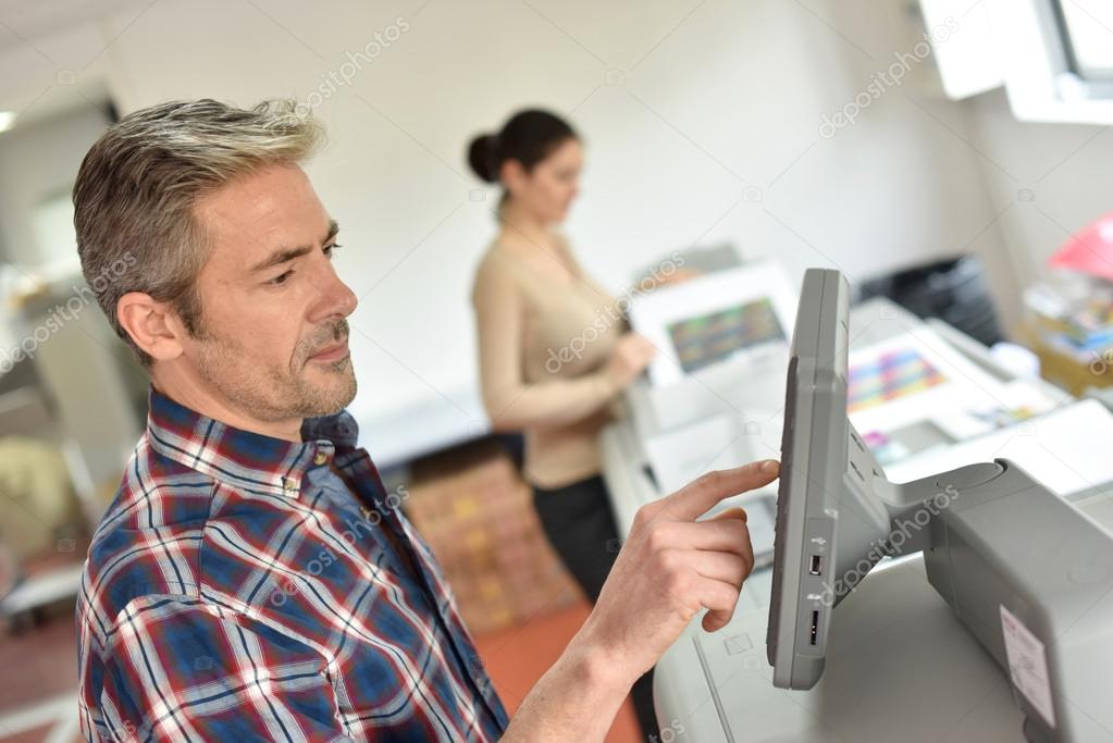 man programming printer machine