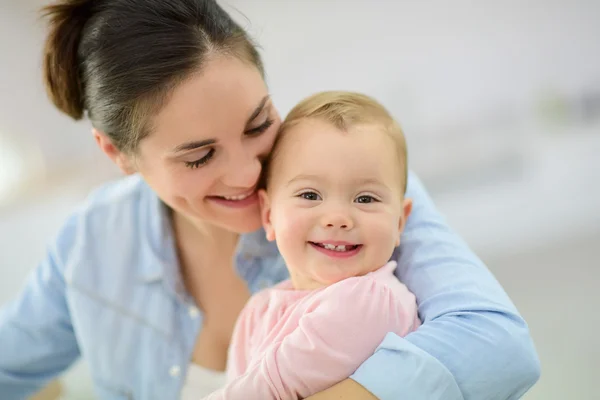 Mother cuddling her baby — Stock Photo, Image