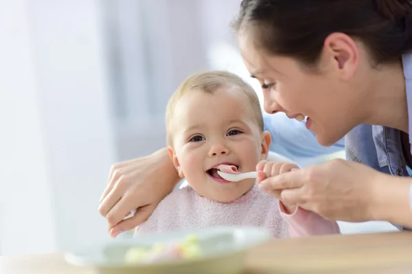Baby girl eating lunch Royalty Free Stock Photos