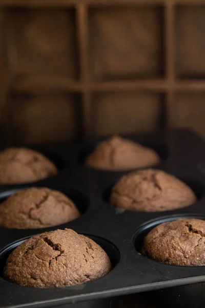 Vers Gebakken Zelfgemaakte Chocoladecupcakes Een Kookvorm Staande Een Houten Tafel — Stockfoto