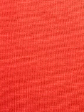 Küçük yuvarlak kaburgalı kırmızı kumaş arka plan. Basit desenli pamuk kumaş. Tasarım için kumaş dokusu arkaplanı.