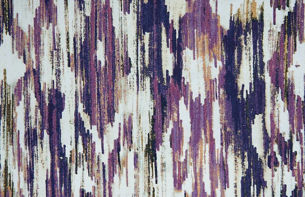 Abstract fabric pattern with embroidery on gray and white with purple fabric. Background texture is a sample for the design.