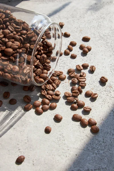 Scattered Glass Jar Coffee Beans Gray Table Sun Light Close — Stock Photo, Image