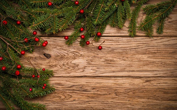 Christmas fir tree on a wooden board — Stock Photo, Image