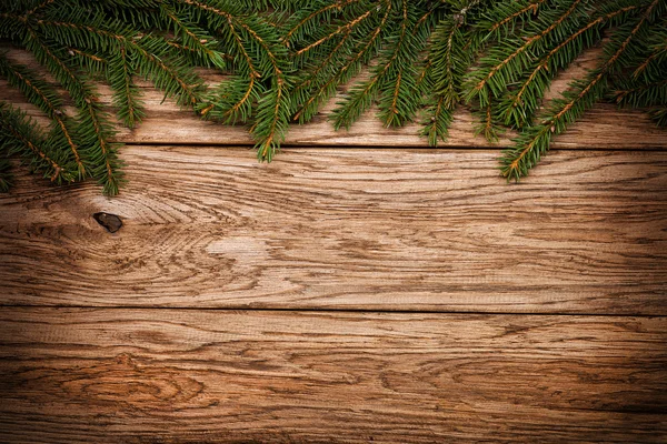 Christmas fir tree on a wooden board — Stock Photo, Image